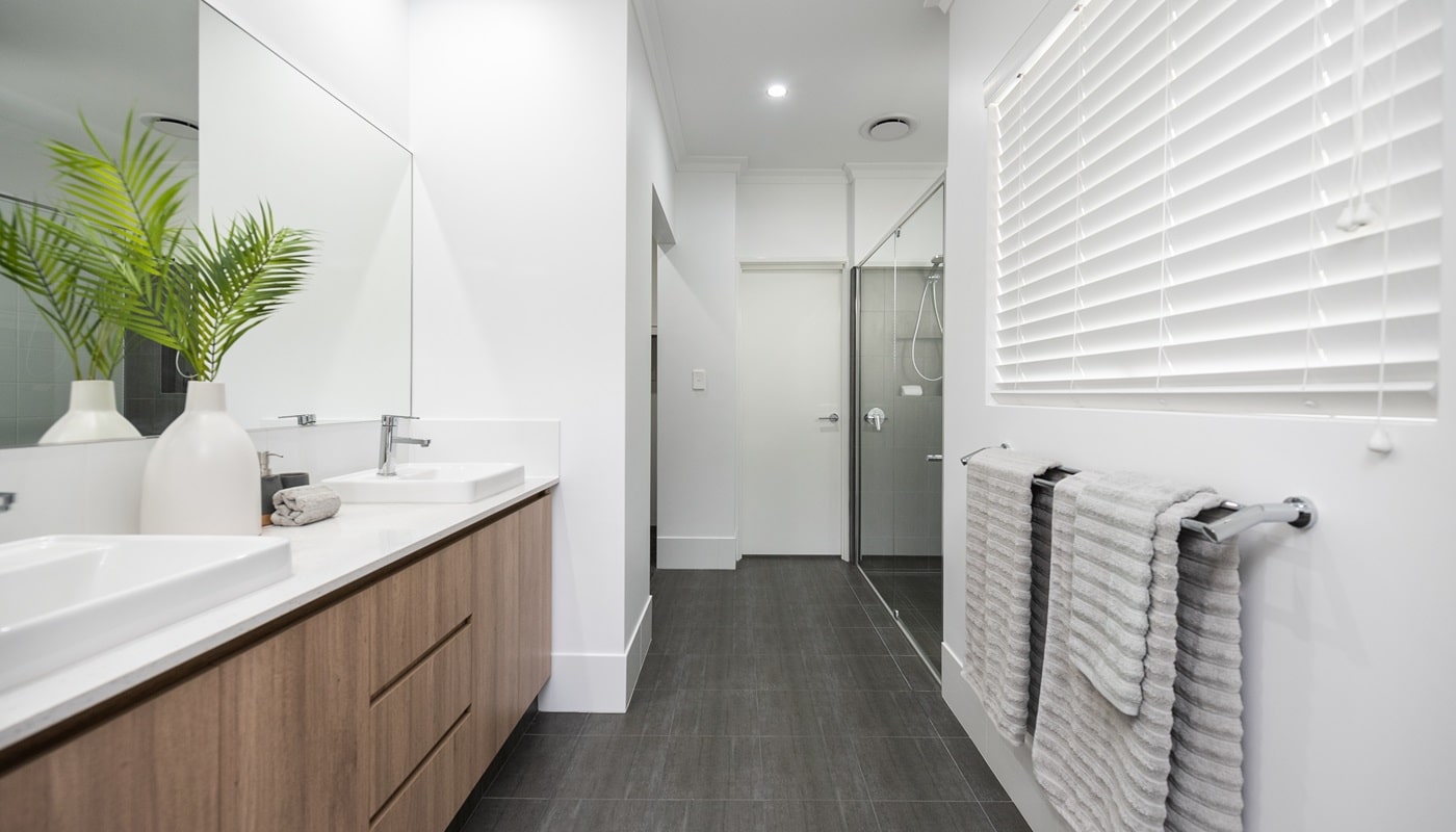 This modern first-home buyer bathroom features quality specifications and inclusions. A double vanity is featured in this home design